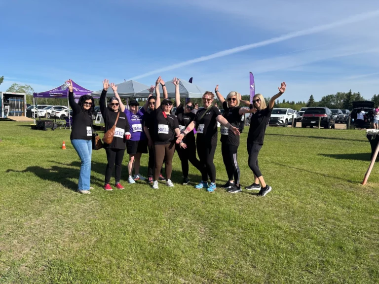 A team from Capital Vision standing together in matching shirts at the Break Free Run and Walk.