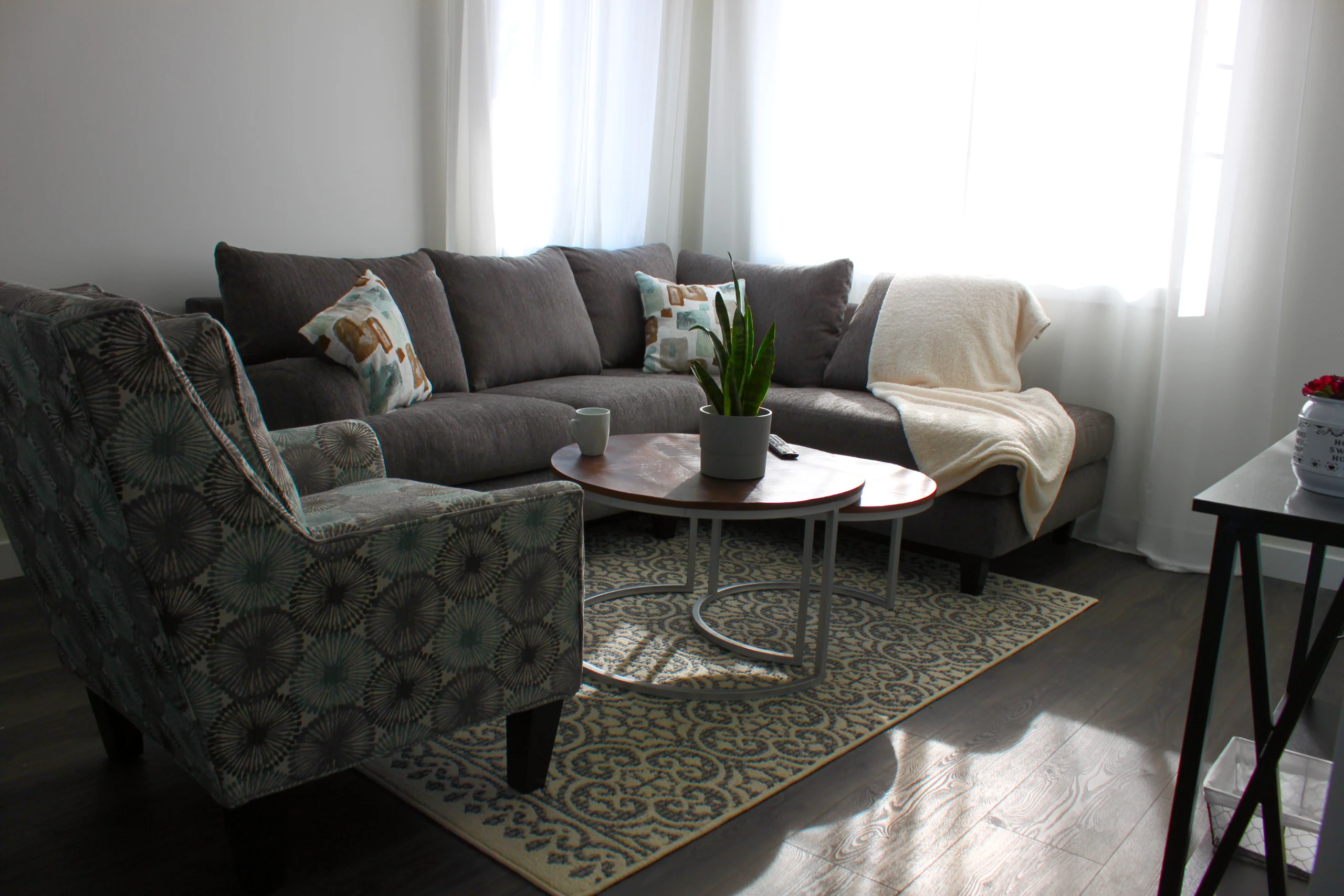 A living room with a sofa and armchair