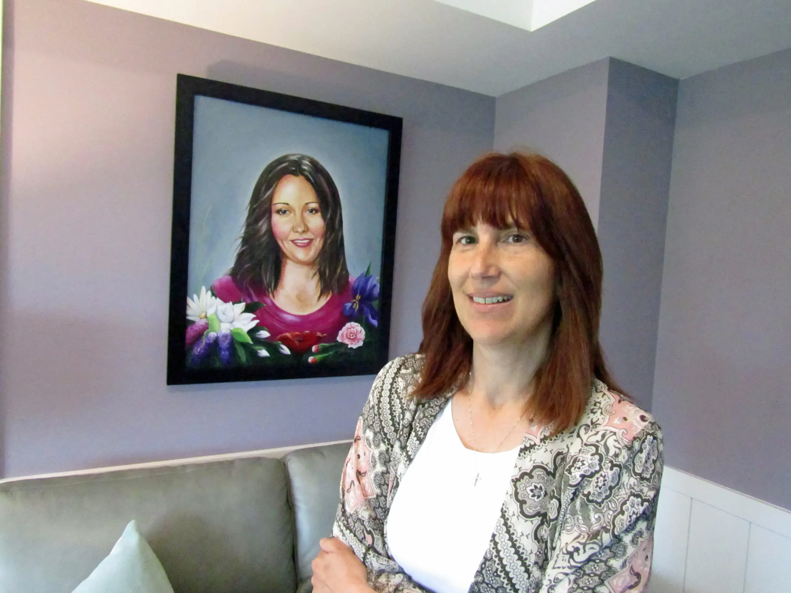 Lynne Rosychuk beside a portrait of Jessica Martel