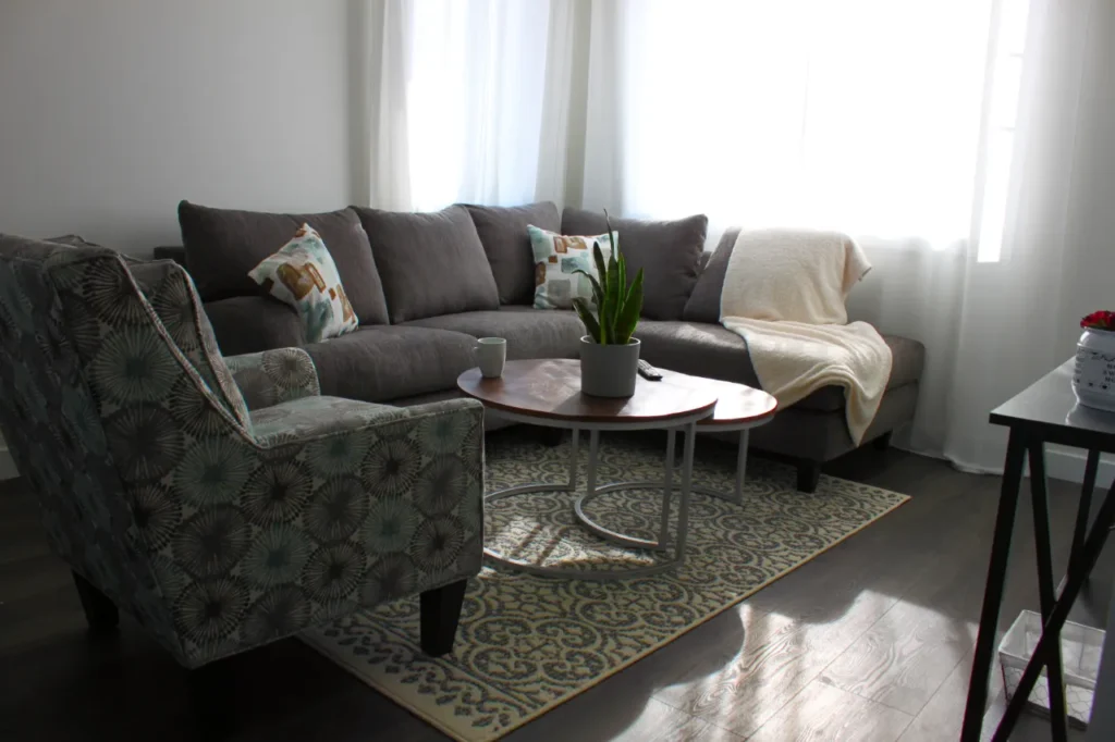 A bright living room with a sofa and armchair
